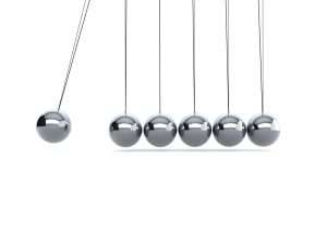 Newton's cradle in motion, kinetic energy demonstration.