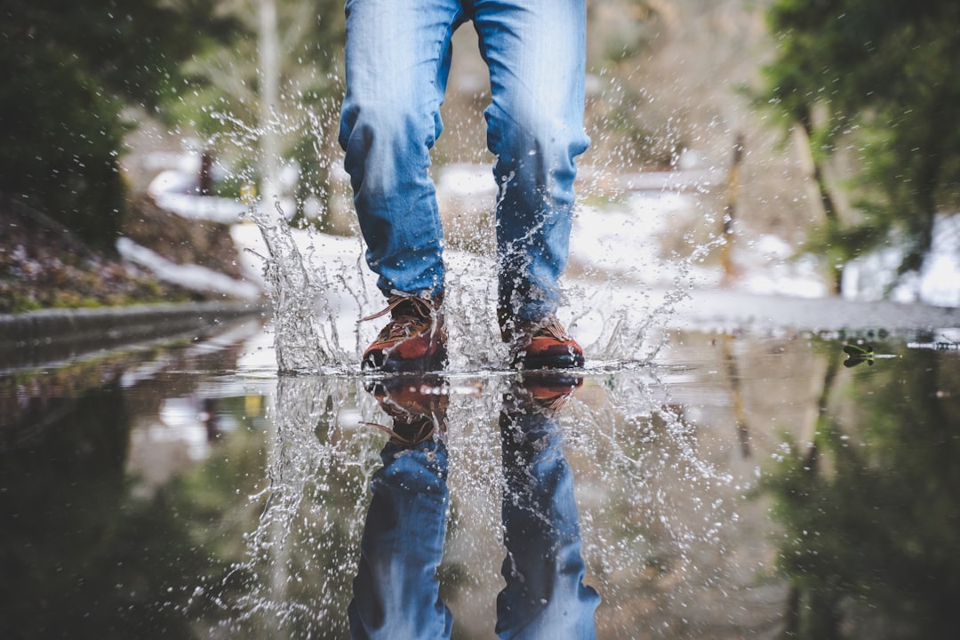 Feet in shallow water representing mindful movement and small approachable steps