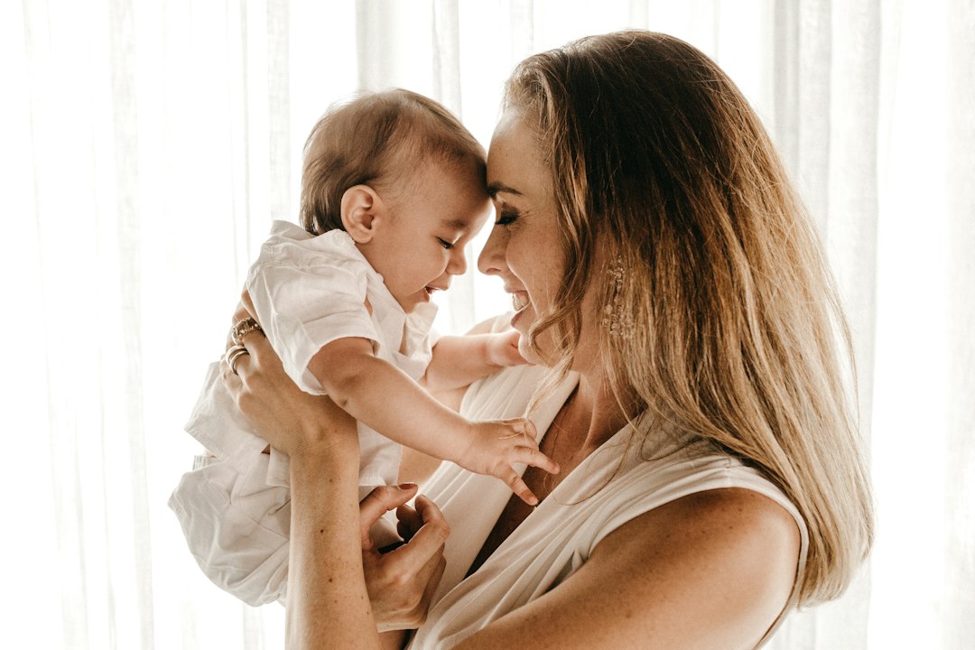 Mother holding a baby at home, illustrating perinatal and postpartum mental health support