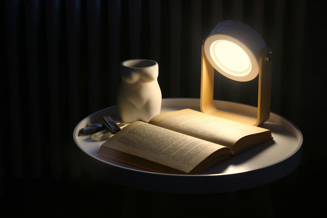 Open book and lamp representing a repeatable relaxing bedtime routine