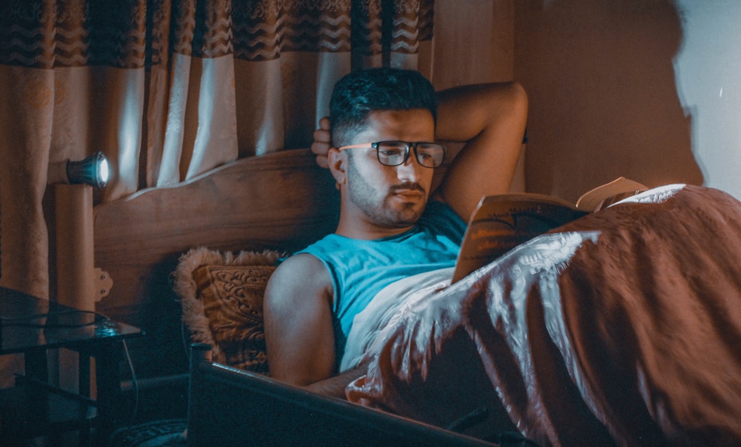 Person using a laptop in the evening representing screen habits that can affect wind-down time