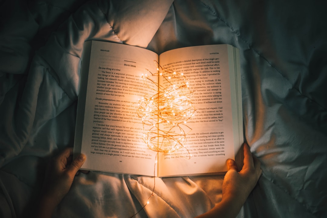 Book in low evening light representing a quiet wind-down routine before sleep