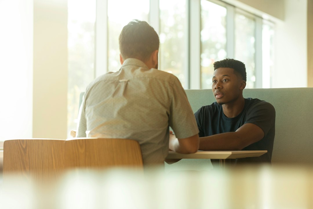 Two people in conversation, representing interpersonal support and mental health.